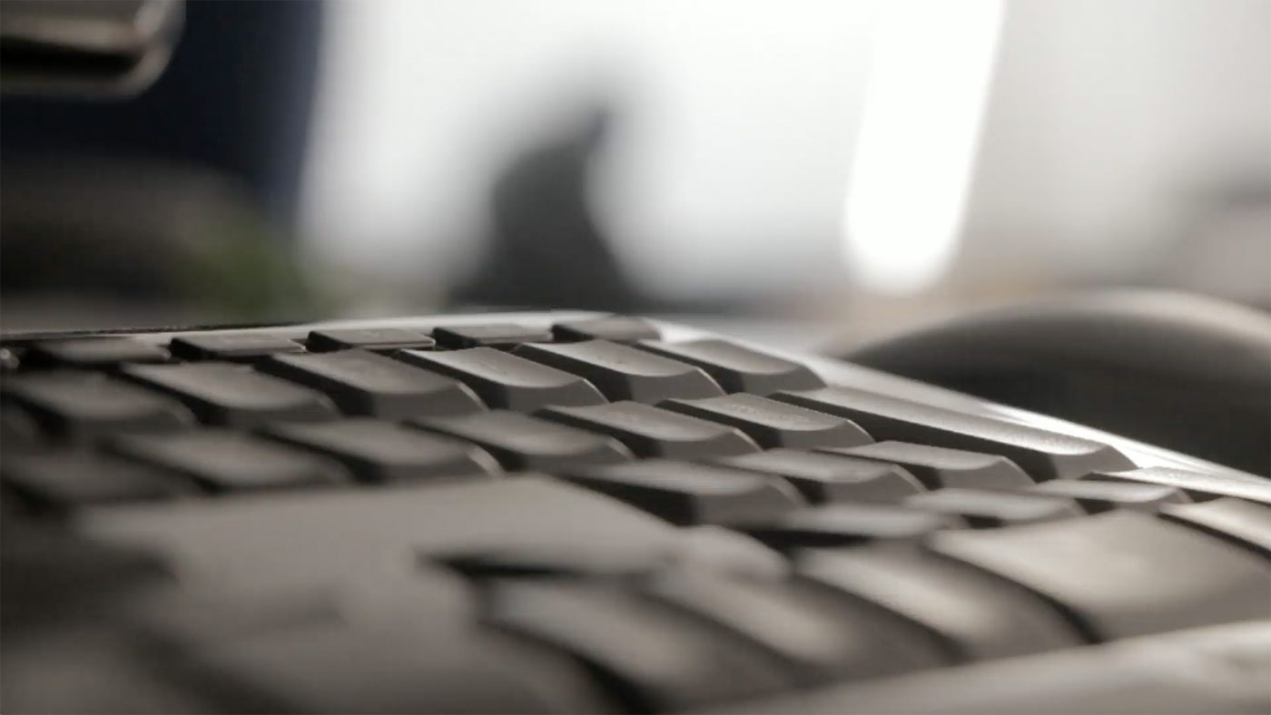 Close-up of hands typing on a laptop keyboard